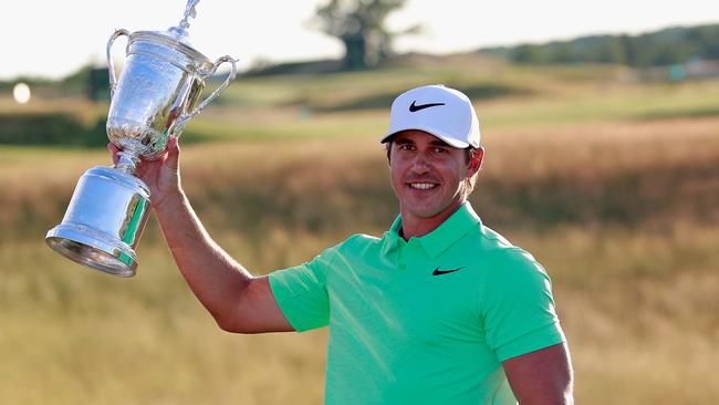 Brooks Koepka of the United States poses with the winner's trophy.