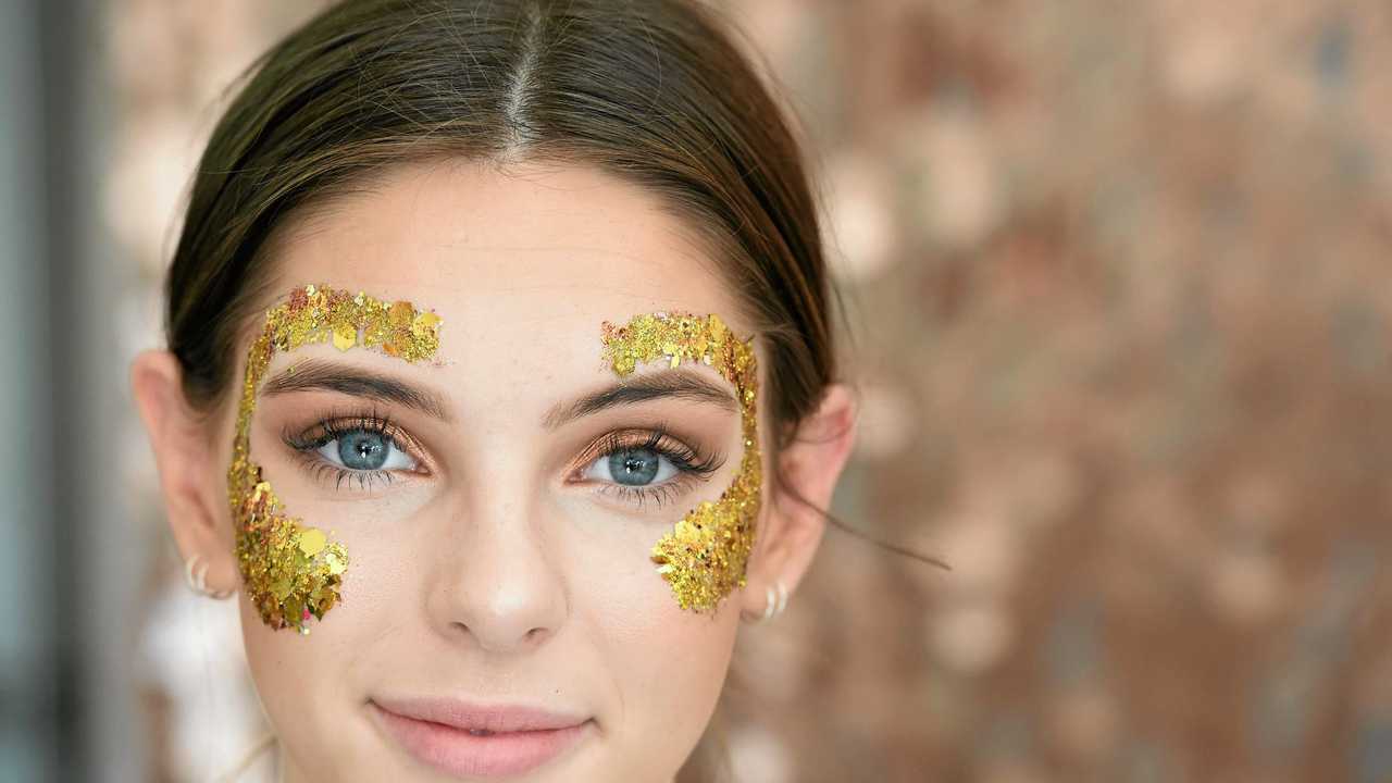 Audrey Clark, of Melbourne, gets glitter fashion on ready for Splendour in the Grass 2017. Picture: Marc Stapelberg