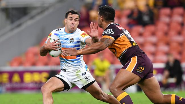 Corey Thompson of the Titans (left) fends off Joe Ofahengaue of the Broncos during the Round 7 NRL match between the Brisbane Broncos and the Gold Coast Titans at Suncorp Stadium in Brisbane, Saturday, June 27, 2020. (AAP Image/Dan Peled)