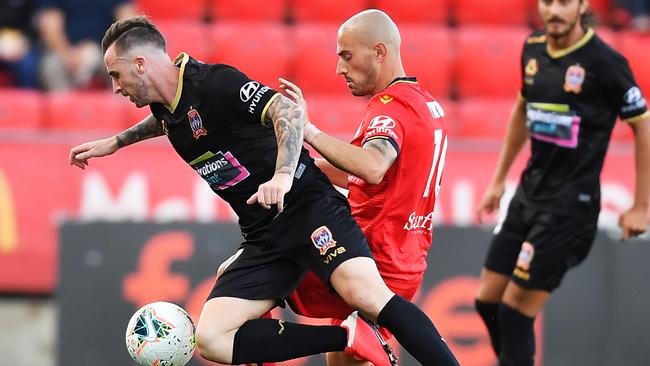 Roy O'Donovan is tackled by James Troisi in United’s 0-3 loss to the Jets. Picture: Mark Brake/Getty Images.