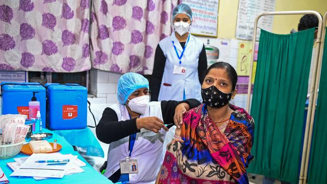 Health officials and a volunteer take part in a mock drill for COVID-19 in New Delhi on Saturday. Picture: AFP