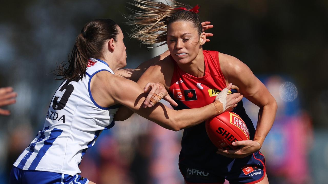 Melbourne ruck Georgia Campbell tries to evade North Melbourne’s Amy Smith during the Demons’ round 3 loss at Casey Fields. Picture: Daniel Pockett / Getty Images