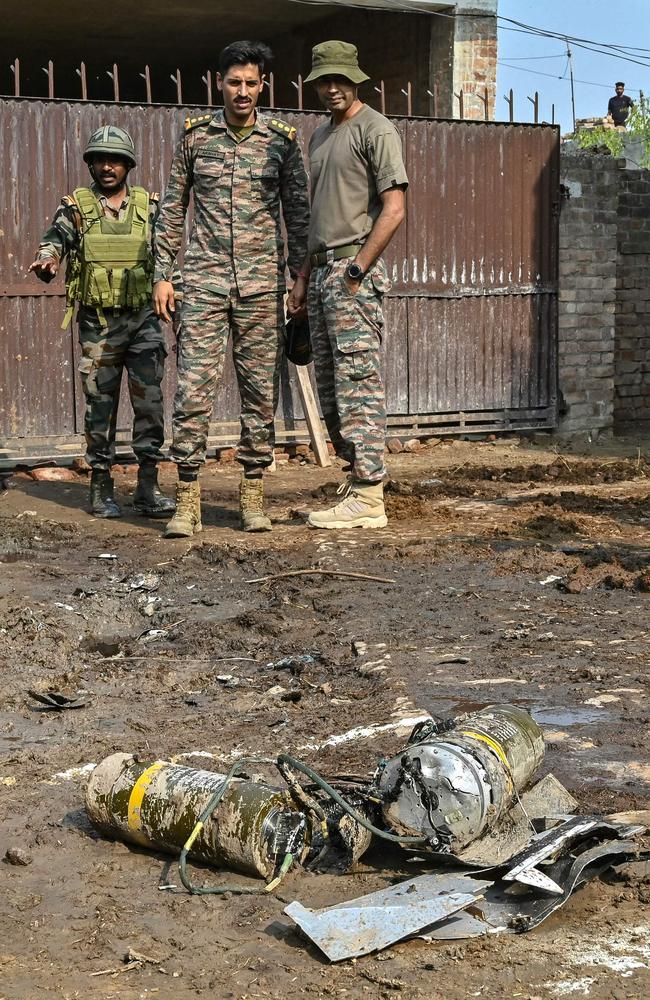 Indian army personnel stand next to explosives, carried by a drone, after it was intercepted by India, on the outskirts of Amritsar, on May 10. Picture: AFP