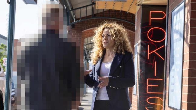 Connie Bonaros speaking to a victim of Pokies on Hindley Street. Picture: Kelly Barnes
