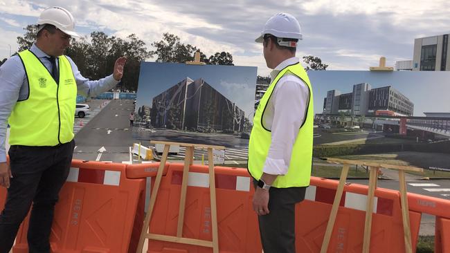 Logan MP Linus Power and Health Minister Steven Miles look over plans for the high rise car park at Logan Hospital.