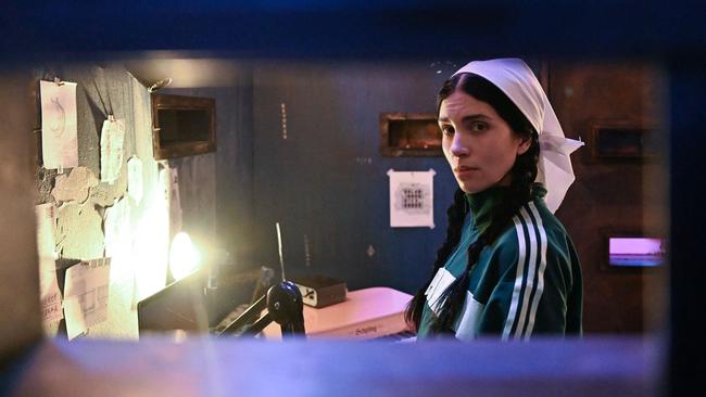 Russian artist Nadya Tolokonnikova, co-founder of Pussy Riot, can be seen inside her mock prison cell during her 10-day durational piece entitled Police State, at the Museum of Contemporary Art in Los Angeles. Picture: Robyn Beck / AFP