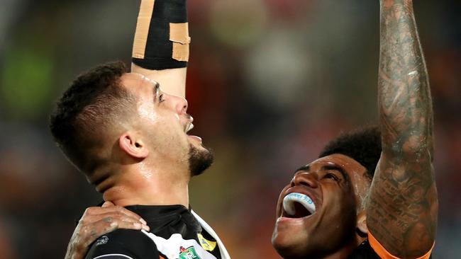 Tigers Josh Aloiai celebrates scoring a try with team mate Kevin Naiqama during the round 20 NRL game between the Wests Tigers and the St George Illawarra Dragons at ANZ Stadium, Homebush. Picture: Gregg Porteous