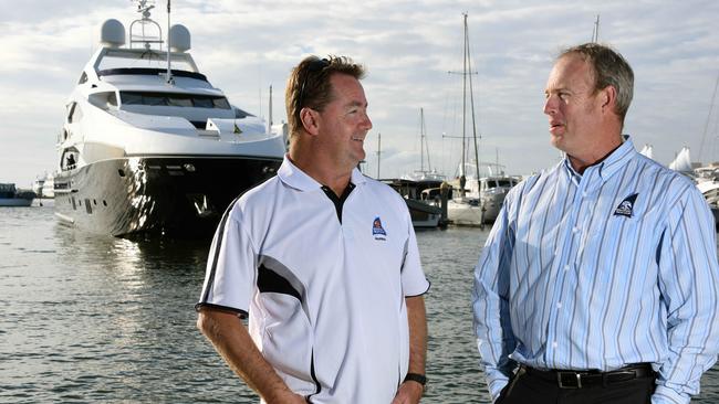 Southport Yacht Club waterfront manager Mark Riddell (left) and general manager Brett James discuss where they are going to put all the superyachts booking in during the Commonwealth Games in April next year, with latest floating palace visitor, Vegas, in the background. Photo: Steve Holland