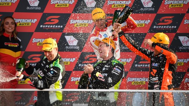 Craig Lowndes (right front) celebrates on the podium with co-driver Steven Richards (left) after the last of his Triple Eight Bathurst 1000 wins in 2018. Picture: AAP