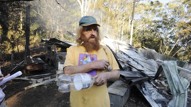 Peter van der Wyk inspects the damage after fire destroyed his Blue Knob house in 2011. Picture: Cathy Adams/The Northern Star