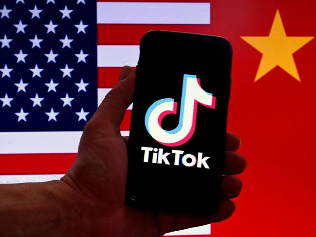 (FILES) In this photo illustration the social media application logo for TikTok is displayed on the screen of an iPhone in front of a US flag and Chinese flag background in Washington, DC, on March 16, 2023. TikTok faces a US ban after an appeals court on December 6, 2024, rejected its challenge to a law requiring the video-sharing app to divest from its Chinese parent company by January 19. The potential ban could strain US-China relations just as president-elect Donald Trump prepares to take office on January 20. (Photo by OLIVIER DOULIERY / AFP)