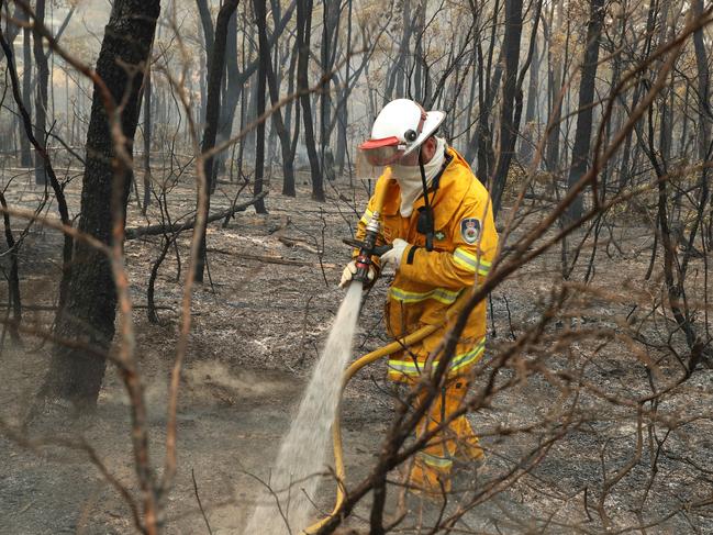 20.12.2019 The NSW Rural Fire Crew from truck Balmoral 1 at work today.  Residents in the township of Balmoral prepare their house in expectation that bush fire conditions will worsen tomorrow (Saturday). The Green Wattle Creek fire has caused devastation over the last few days including lost houses.Picture Rohan Kelly