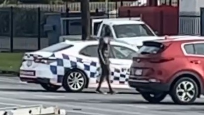 A man armed with a pole and machete allegedly smashed the window of a car before driving off in a stolen police patrol vehicle. Picture: Supplied