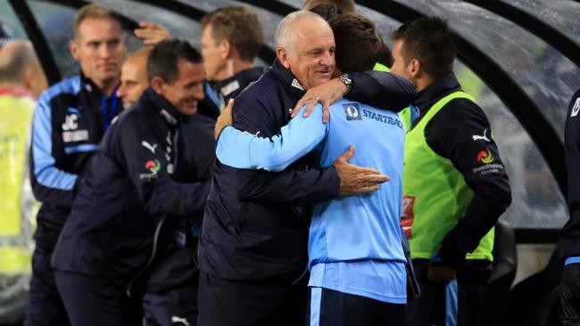 Graham Arnold thanks his staff after Sydney FC’s win over Melbourne Victory.