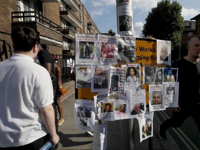 Posters of people missing are stuck to a lamp post near Grenfell Tower. Picture: AP