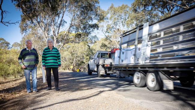 Jill and Ian Williams view the uneven road outside their property on Inman Valley Rd, Inman Valley (near Hancock Rd intersection). Picture: Emma Brasier