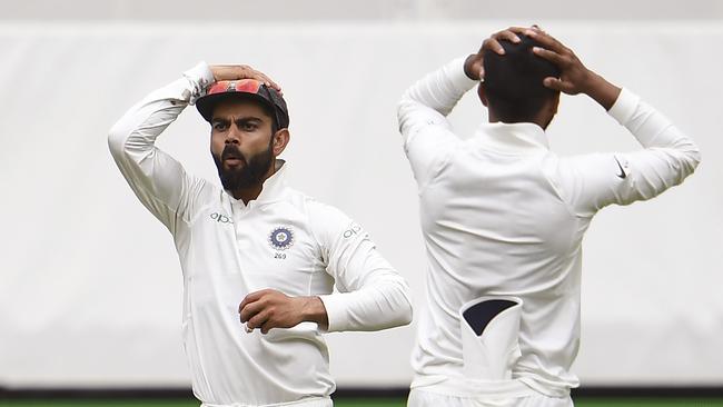 India's Virat Kohli (L) and a teammate reacts after a missed opportunity from an Australian batsman on the third day of the second cricket Test match in Perth on December 16, 2018. (Photo by WILLIAM WEST / AFP) / --IMAGE RESTRICTED TO EDITORIAL USE - STRICTLY NO COMMERCIAL USE--