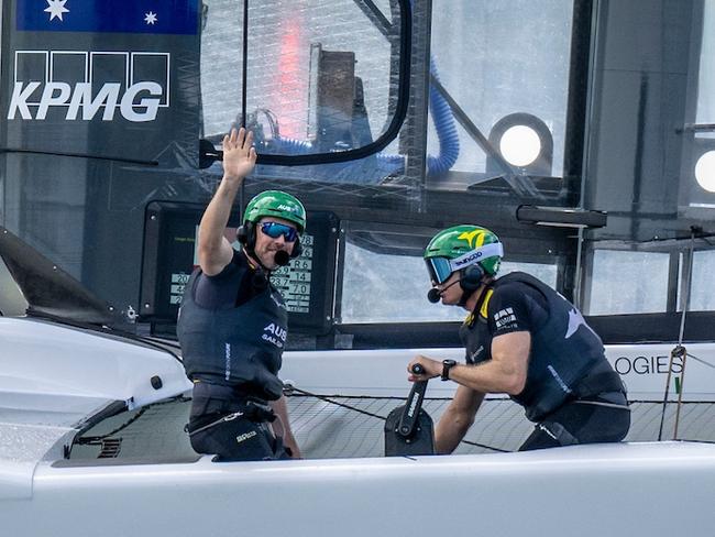 Australia SailGP Team helmed by Tom Slingsby in action as Kinley Fowler, grinder of Australia SailGP Team, waves to the spectators during the KPMG Australia Sail Grand Prix in Sydney in February.