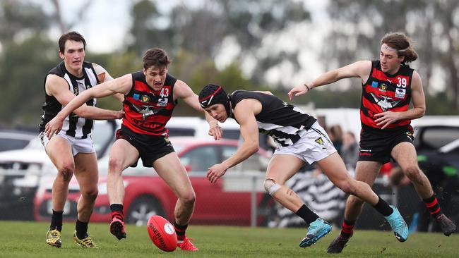 Aiden Grace of Glenorchy, left, takes on Lauderdale’s Josh McGuinness as Magpie Ryan Banks-Smith attacks the ball ahead of Bomber Liam Gallagher. Picture: NIKKI DAVIS-JONES