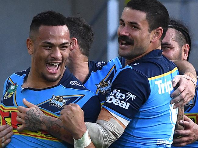 Phillip Sami of the Titans (left) celebrates scoring a try during the Round 20 NRL match between the Gold Coast Titans and the Warriors at Cbus Super Stadium on the Gold Coast, Sunday, July 29, 2018. (AAP Image/Dave Hunt) NO ARCHIVING, EDITORIAL USE ONLY