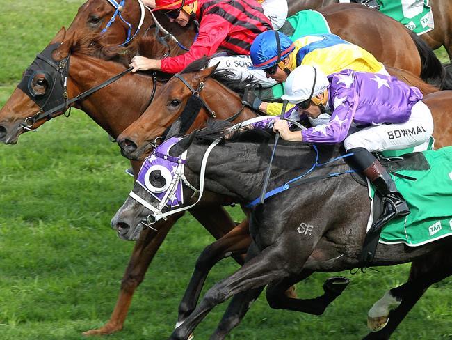 Foxplay, ridden by Hugh Bowman (purple blinkers), arrives at the right time at Royal Randwick. Picture: Jenny Evans