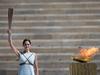 TOPSHOT - Greek actress Xanthi Georgiou dressed as an ancient Greek high priestess holds the olympic torch during the olympic flame handover ceremony for the 2020 Tokyo Summer Olympics, on March 19, 2020 in Athens. (Photo by ARIS MESSINIS / various sources / AFP)