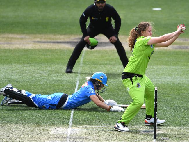 Katie Mack scrambles home for an important third run as Sydney Thunder’s Hannah Darlington tries to run her out. The Strikers went on to win this game in a super over at Blundstone Arena on November 24. Picture: STEVE BELL/GETTY IMAGES