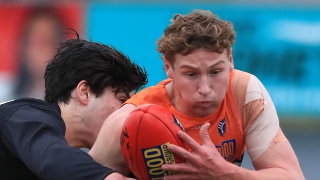 Football GFL Round 12: Geelong West v Newtown &amp; Chilwell. Geelong West 41 Charlie Leavold is tackled by Newtown &amp; Chilwell 44 Connor Fopiani Picture: Mark Wilson