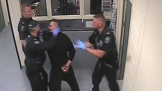 Nathan Cross, centre, looks at Senior Constable Ben Higgins, on his left, moments before the incident. Image: Supplied.