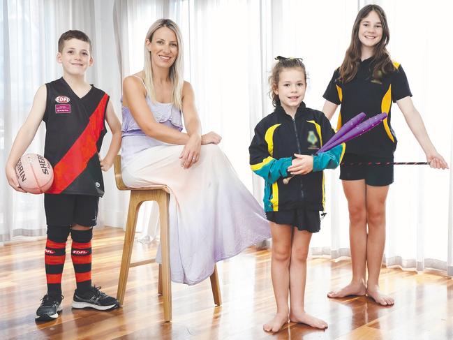Angelique Woodburn with her three children Sophie 11, Leo 9 and Ivy 7. The girls do calisthenics while Leo plays Australian Rules Football. Picture: Ian Currie