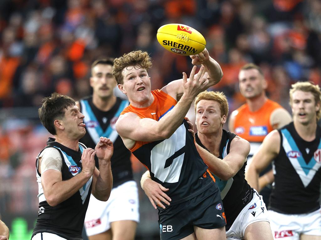 Giants Tom Green handballs under pressure from Port Adelaide's Zak Butters and Willem Drew during the AFL Round 14 AFL match between the GWS Giants and Port Adelaide Power at Engie Stadium, Sydney on June 16, 2024. Photo by Phil Hillyard (Image Supplied for Editorial Use only – **NO ON SALES** – Â©Phil Hillyard )