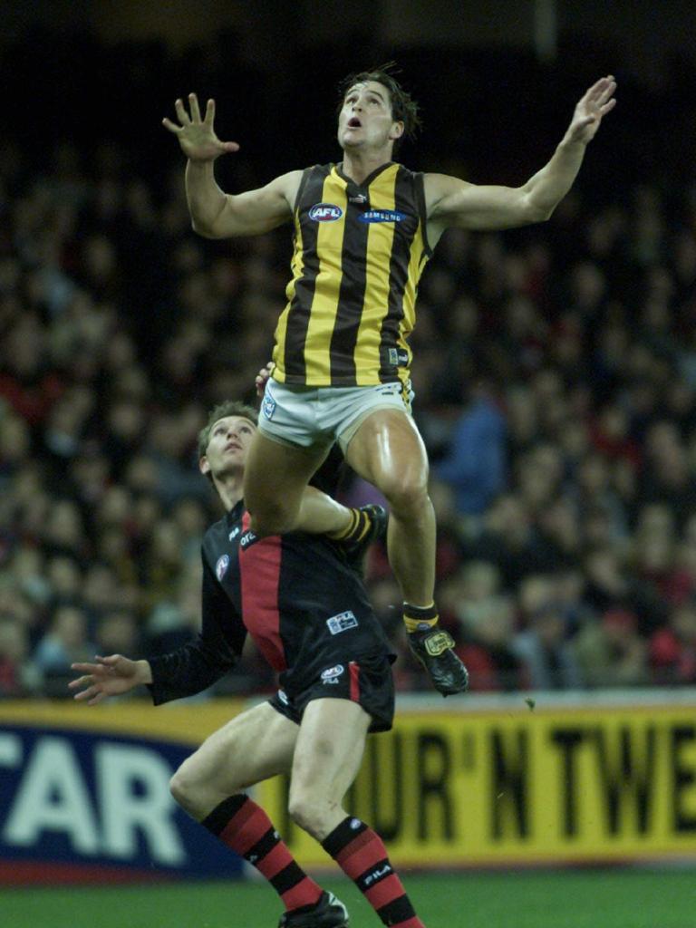 Soaring for a hanger over James Hird.