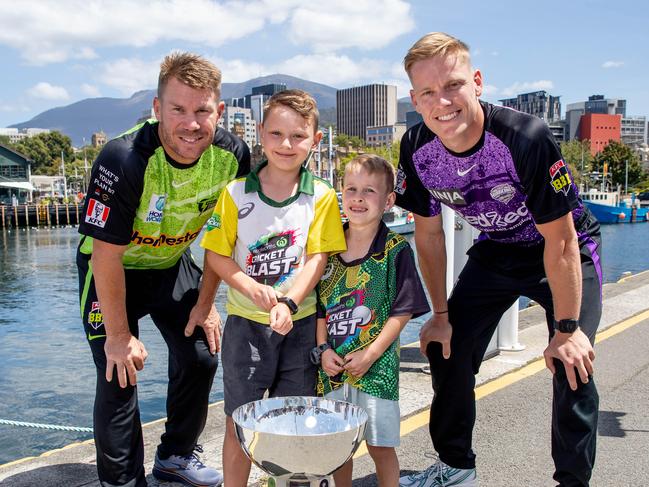 Sydney Thunder captain David Warner and Hobart Hurricanes captain Nathan Ellis in Hobart ahead of the BBL Final with lucky fans Julian and William Cashman. Picture: Linda Higginson.