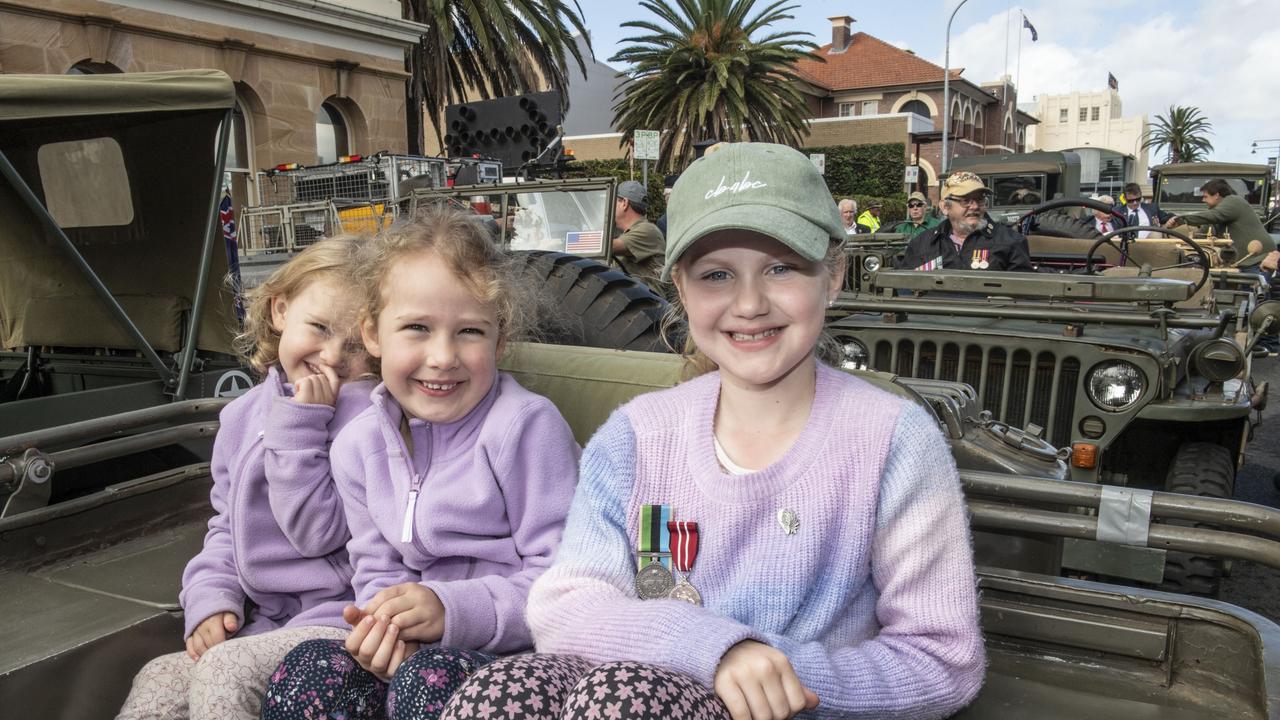 (from left) Ella Connolly, Chloe Connolly and Peyton Locke with her grandfathers medals. Assembly in Neil St for the mid morning parade on ANZAC DAY. Tuesday, April 25, 2023. Picture: Nev Madsen.