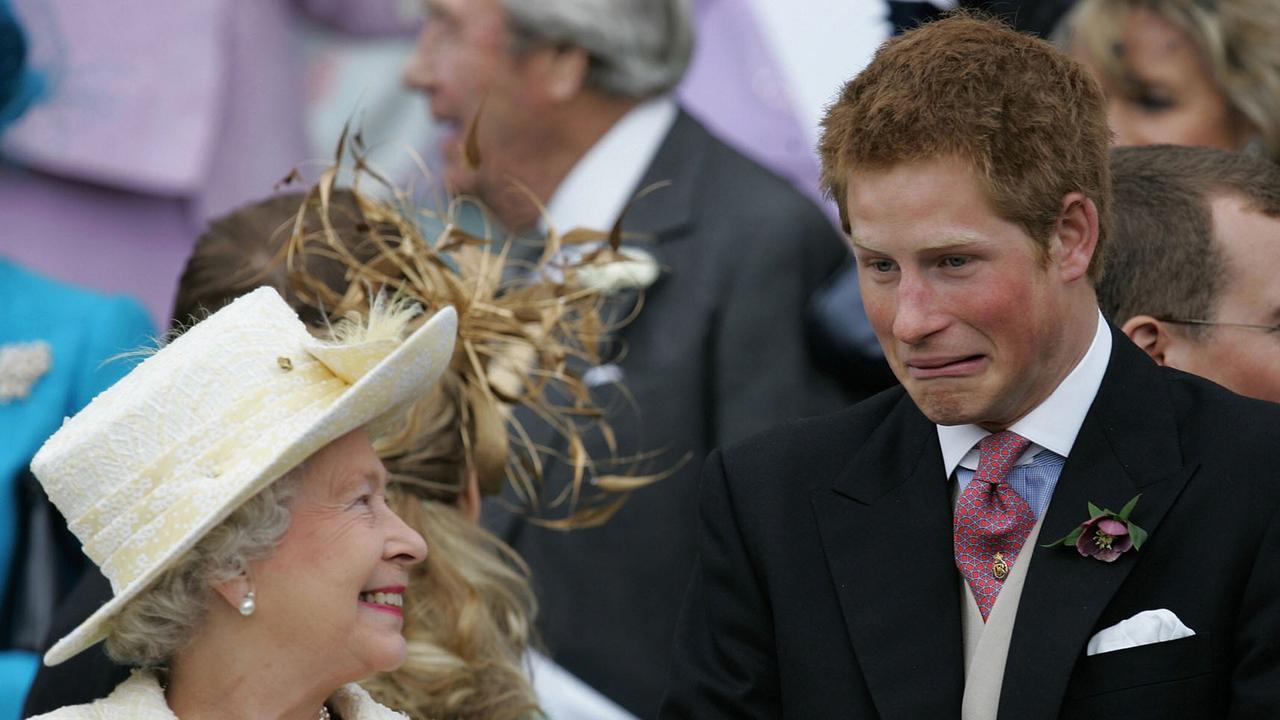 Britain's Queen Elizabeth II and Prince Harry share a joke as they watch Prince Charles and his bride Camilla Duchess of Cornwall leave St George's Chapel in Windsor following their marriage blessing. Picture: Getty