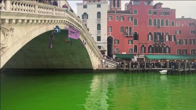 Climate change protesters turn Venice canal green