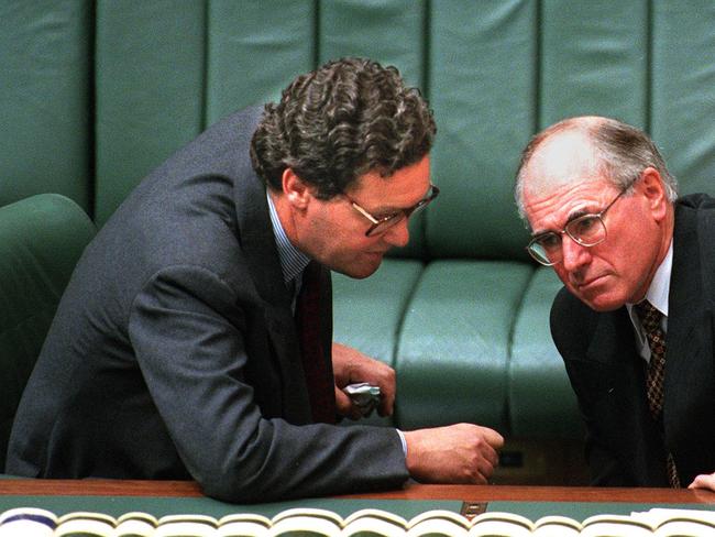 Aust politician Prime Minister John Howard (r) with Alexander Downer during Question Time in Parliament.