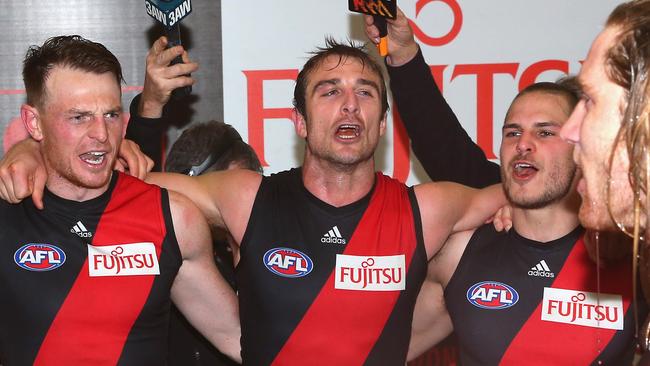 MELBOURNE, AUSTRALIA - AUGUST 16: Brendon Goddard, Jobe Watson, David Zaharakis and Ariel Steinberg of the Bombers sing the song in the rooms after winning the round 21 AFL match between the Essendon Bombers and the West Coast Eagles at Etihad Stadium on August 16, 2014 in Melbourne, Australia. (Photo by Quinn Rooney/Getty Images)