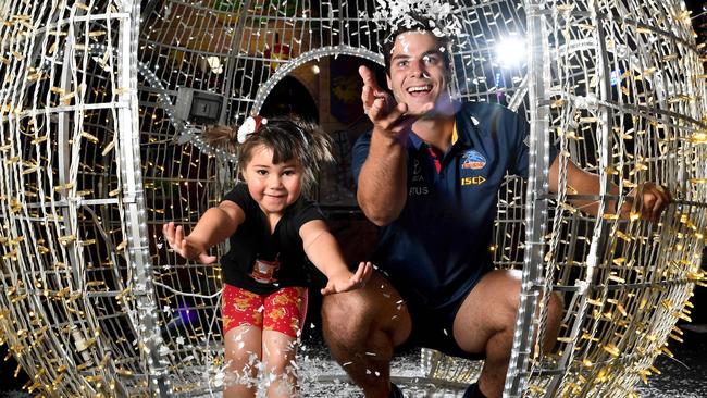 Adelaide Crows forward Darcy Fogarty with Luna, 4, at Santa's Wonderland, Adelaide Showgrounds, this week. Picture: Tricia Watkinson