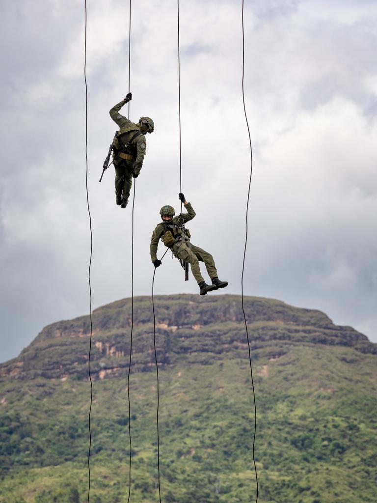 More Colombian National Police officers fast rope on to the ground. Picture: Jason Edwards