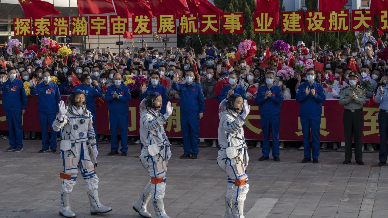 (L-R) Chinese astronauts and crew of the Shenzhou-16 Gui Haichao, Zhu Yangzhu and mission leader Jing Haipeng from China's Manned Space Agency wave to wellwishers at a pre-launch departure ceremony on May 30, 2023. (Photo by Kevin Frayer/Getty Images)
