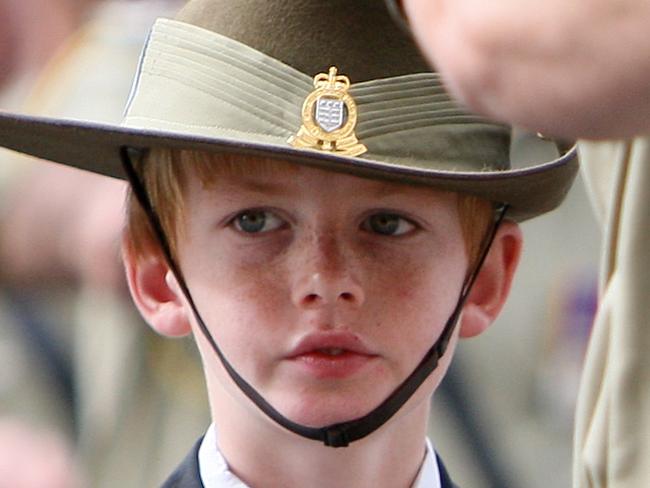 A young boy proudly marches in the parade. Annual ANZAC Day Parade makes it way along St George's Terrace, Perth.