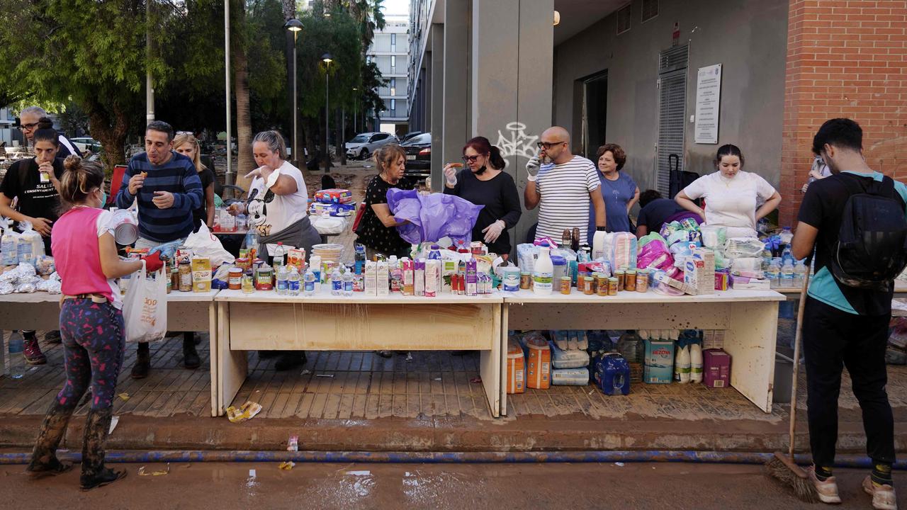 Volunteers give out supplies in Benetusser on November 2. Spain will deploy 10,000 more troops and police officers to the eastern Valencia region impacted by the floods, Prime Minister Pedro Sanchez said. Picture: Manaure Quintero/AFP