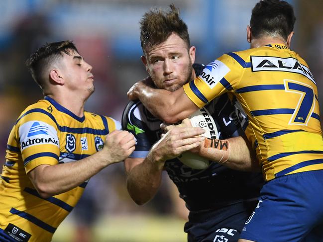 TOWNSVILLE, AUSTRALIA - MAY 18: Gavin Cooper of the Cowboys is tackled by Mitch Moses  and Reed Mahoney of the Eels during the round 10 NRL match between the North Queensland Cowboys and the Parramatta Eels at 1300SMILES Stadium on May 18, 2019 in Townsville, Australia. (Photo by Ian Hitchcock/Getty Images)