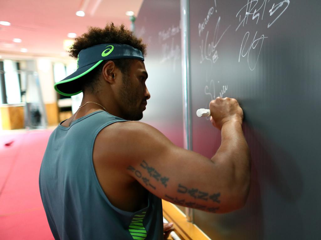 Will Genia of Australia signs a board for hotel staff following their last gym session on September 17, 2019 in Odawara, Japan. (Photo by Dan Mullan/Getty Images)