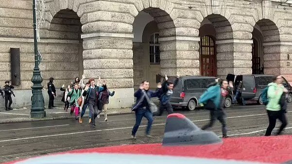 Crowds fleeing Charles University in the Czech capital with their hands in the air. Picture: X