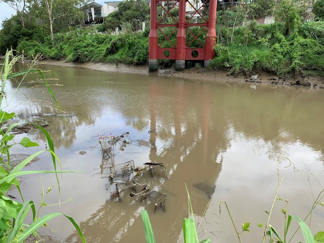 Crews begin work to remove over thirty shopping trolleys dumped in the Bremer River at Riverbank.