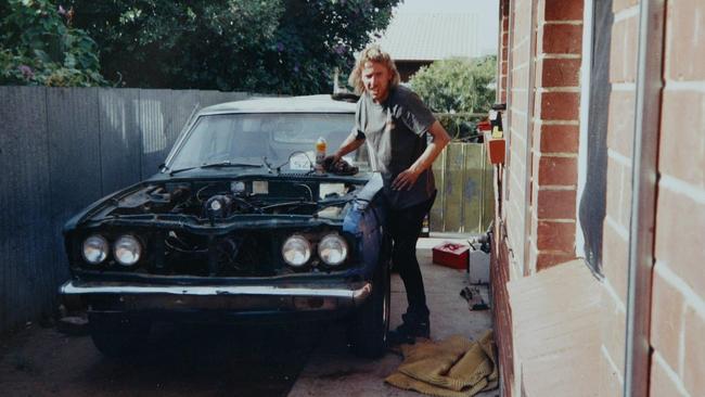 Robert Woodland working on a car in the 1990s.