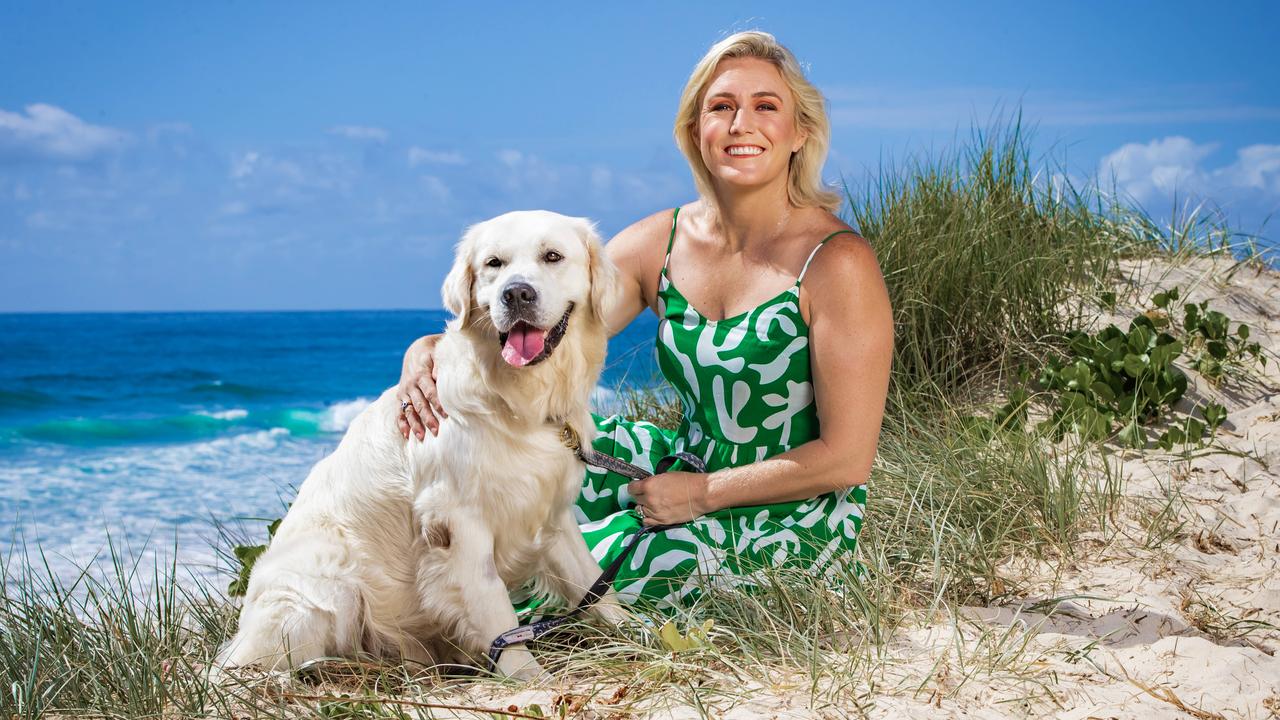 Sally Pearson pictured with her pooch Max enjoy a trip to the beach on the Gold Coast. Picture: Nigel Hallett