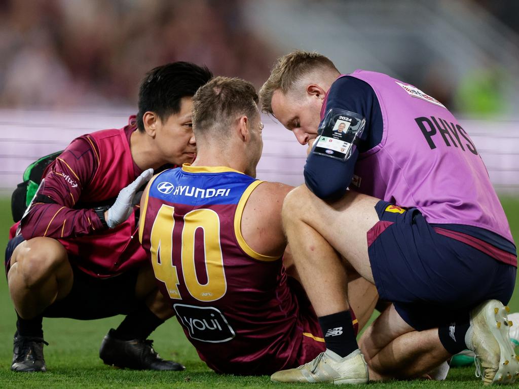 Jack Payne is checked by trainers after being injured against Carlton. Picture: Russell Freeman/AFL Photos via Getty Images